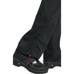 A pair of black pants with a gathered design at the ankles and a pink drawstring, worn with black clogs.