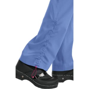 Light blue spirit pants with a gathered detail at the hem, paired with black clogs. The pants feature a decorative drawstring.