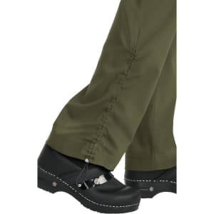 A pair of olive green pants with gathered detailing at the ankles, worn with black clogs.