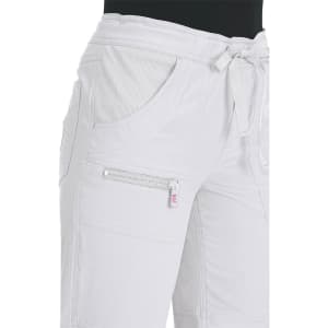 White pants featuring a drawstring waistband and multiple pockets. The fabric has a textured finish and includes branding.