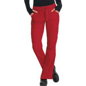 Red pants with a drawstring waist and pockets, designed for comfort and style. The model wears a black long-sleeved top.