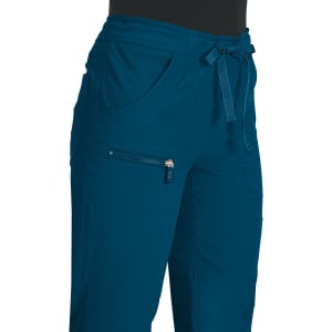 A pair of teal pants featuring a drawstring waist and multiple pockets, including a zippered one.