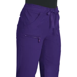 A pair of purple pants featuring pockets and a tie waist, with a small logo on the side.