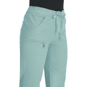 A pair of light mint green pants with pockets and a drawstring waist, featuring a zippered pocket.