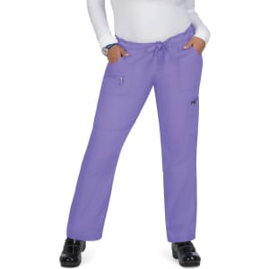 A pair of purple pants with pockets and a drawstring waist, worn by a person standing with hands in pockets.