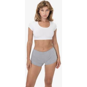 A model wearing grey interlock running shorts paired with a white crop top, showcasing a fitted design and casual style.