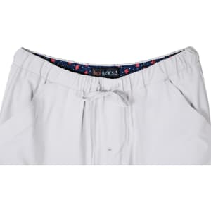A pair of white pants featuring an elastic waistband with a patterned inner lining and a drawstring.