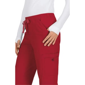 A pair of red pants featuring a drawstring waist and side pockets, displayed on a model wearing a white top.