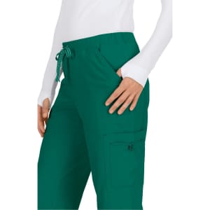 Green pants with an elastic waistband and a side pocket, worn by a person in a white long-sleeve top.