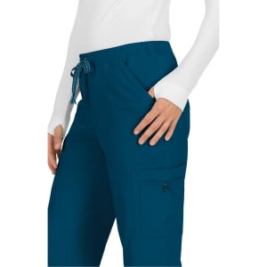 Teal pants with a drawstring waist and side pockets, featuring a logo on the pocket.
