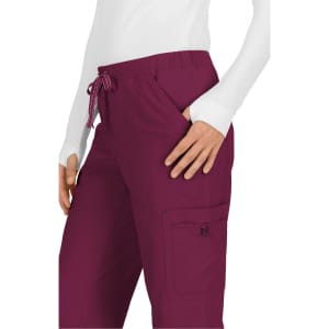 A pair of burgundy pants featuring a drawstring and side pockets, with one zippered pocket on the side.