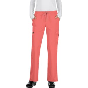 A pair of coral-coloured pants with pockets and a drawstring waist, displayed on a model.