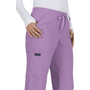 A pair of lavender scrubs with a drawstring waist, featuring side pockets and a logo patch.