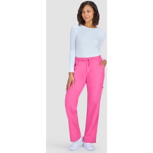 A woman wearing bright pink pants with a drawstring waist and a light long-sleeve top. The pants have a side pocket.