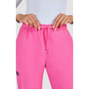 A pair of bright pink pants featuring a drawstring waist and a pocket, with a logo on the side.