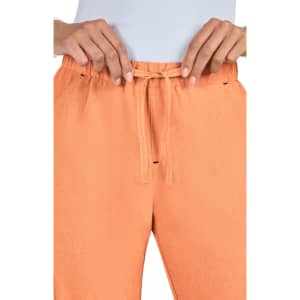 An orange pair of pants featuring a drawstring waistband and front pockets, with a focus on the waist area.