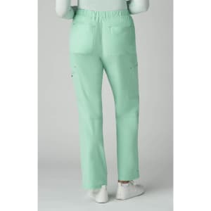 Mint green trousers with multiple pockets, featuring a relaxed fit and elastic waistband. The model is wearing white shoes.