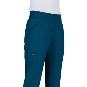 A pair of teal pants with pockets, featuring an elastic waistband and a logo on the side.