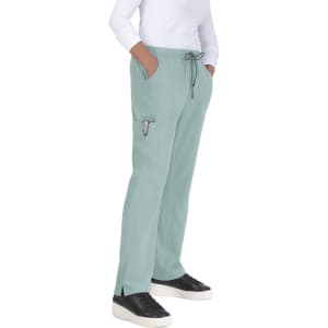 Everyday Hero Pant in a soft green colour, featuring a drawstring waist and side pockets, worn by a model.