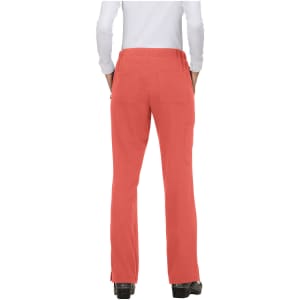 A pair of coral pink pants viewed from the back, featuring pockets and a logo.