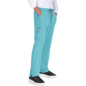 A pair of turquoise pants with pockets and a drawstring waist, worn with a white top and black sneakers.