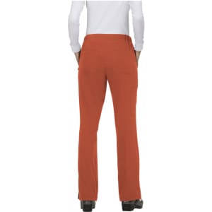 A pair of orange pants viewed from the back, featuring a fitted waist and a single back pocket.