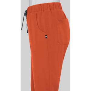 An orange pair of pants with an elastic waistband and side pockets, featuring a small logo on the side.