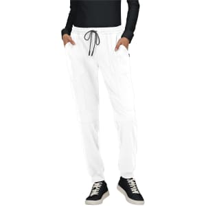 A pair of white jogger pants with pockets, featuring an elastic waistband and drawstring, styled with a black top and shoes.