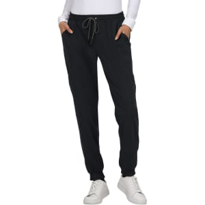 A pair of black jogger pants with pockets and a drawstring waistband, worn with a white long-sleeve top.