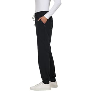 A side view of black jogger pants with a drawstring waistband, featuring pockets and a casual fit.