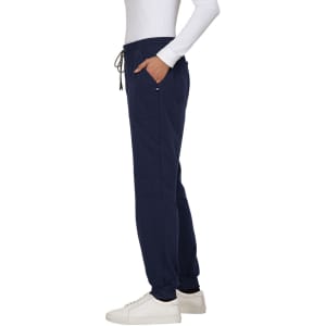 A pair of navy jogger pants with pockets and a drawstring waist, worn with a white long-sleeve top and white shoes.