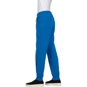 A pair of blue jogger pants with an elastic waistband and side pockets, modelled against a plain background.