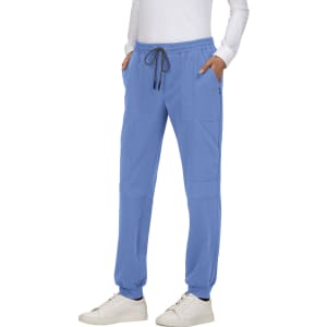A pair of blue jogger pants with pockets, featuring an elastic waistband and drawstring, worn by a person.
