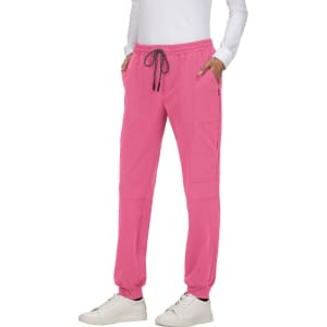 A pair of pink jogger pants with an elasticated waist and side pockets, featuring a drawstring and a logo.