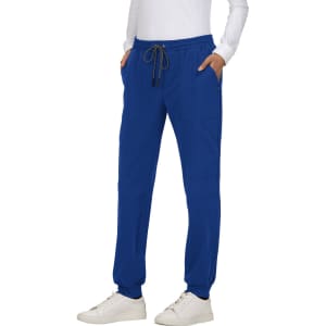 A pair of blue jogger pants with pockets and a drawstring waistband, featuring a logo, styled with a white top.
