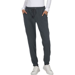 A pair of grey jogger pants with a drawstring waist and side pockets, worn with a white long-sleeve top.
