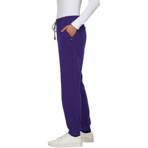 A pair of purple jogger pants featuring pockets and an elastic waistband. The pants are styled with a side view.