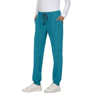 Turquoise jogger pants with a drawstring waist and side pockets, featuring a branding logo.