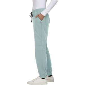 Light blue jogger pants featuring side pockets and a drawstring waistband, paired with white sneakers.