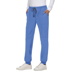 A pair of blue jogger pants featuring pockets and a drawstring waist, styled with a white top and sneakers.