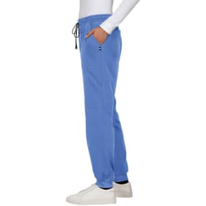 A pair of blue jogger pants with pockets and an elastic waistband, styled with a white long-sleeved top.