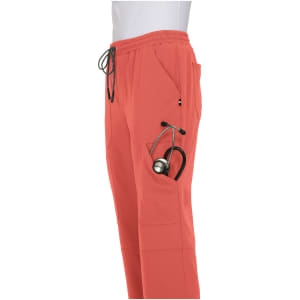 Coral jogger pants with pockets, featuring a stethoscope in one pocket. The pants have an elastic waistband and drawstring.