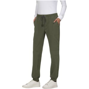 A pair of olive green jogger pants with pockets, featuring an elastic waistband and drawstring. A logo is present.
