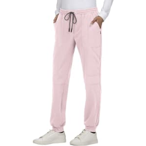 Light pink jogger pants with a drawstring waist, side pockets, and a branded logo located on the leg.