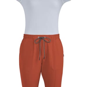 A pair of rust-coloured jogger pants with an elastic waistband and two front pockets, featuring a drawstring.