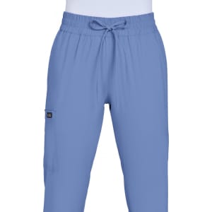 A pair of light blue jogger pants with an elastic waistband and side pockets. The pants feature a branding logo.