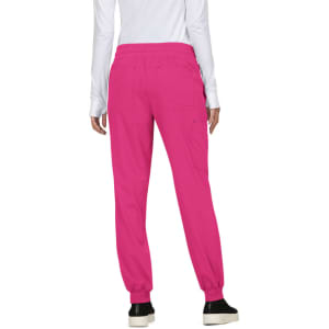 A woman wearing bright pink jogger pants with an elastic waistband and pockets, viewed from the back.