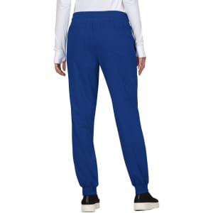 A person wearing blue jogger pants with an elastic waistband and cuffed ankles, featuring pockets and a logo.