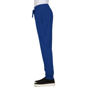 A pair of royal blue jogger pants with an elastic waistband and pockets, worn with black shoes.