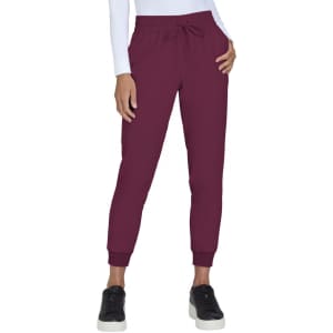 A pair of burgundy jogger pants with a drawstring waist and elastic cuffs, worn by a model.